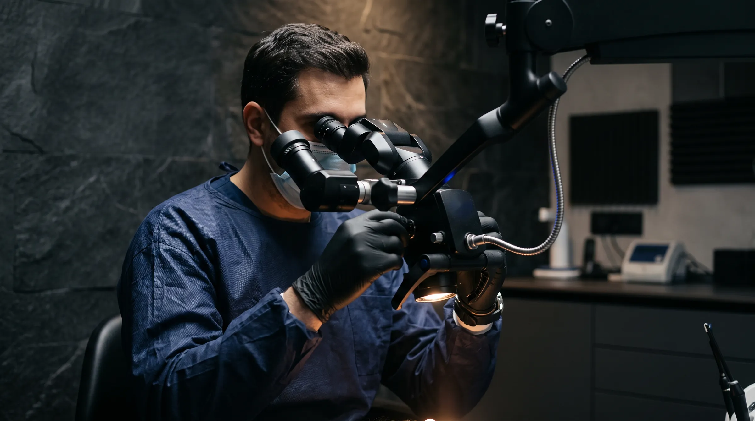 A dentist working at the operating microscope